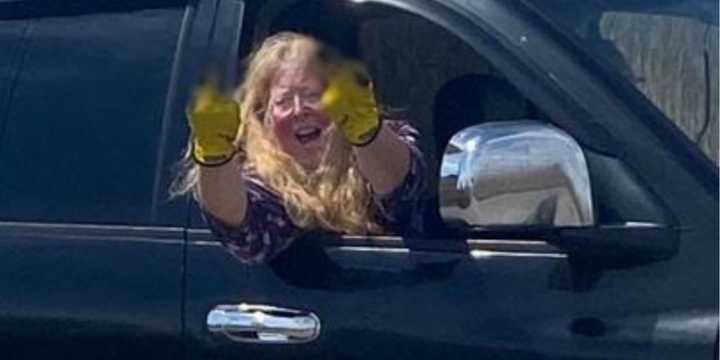 Judith Monasterolo gives a witness two middle fingers after illegally dumping items at a Mastic Beach wetland in April 2023.