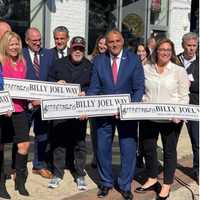 <p>Billy Joel with local officials during an unveiling ceremony for his namesake Billy Joel Way in Oyster Bay on Thursday, Oct. 19.</p>