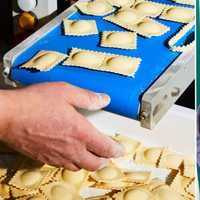 <p>Steve Gonzalez and Kate Galassi opened their new pasta shop, Via Ravioli, on Route 9W in Coxsackie on Wednesday, March 6. Left: Fresh ravioli rolling off the machine.&nbsp;</p>