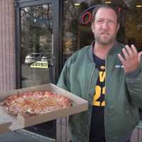 <p>Dave Portnoy tries Prima Pizzeria in Schenectady during a One Bite Pizza Review on Tuesday, April 9.&nbsp;</p>