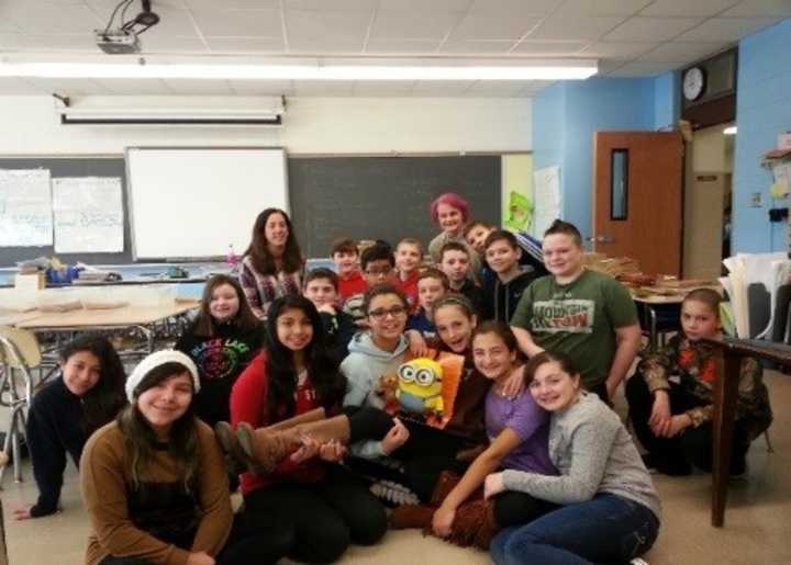 George Fischer Middle School sixth-graders conquered and surpassed the million page challenge by reading a total of 1,336,206 pages since the fall. The school Librarian, Elizabeth Krieger, back row, was so impressed, her hair turned pink.