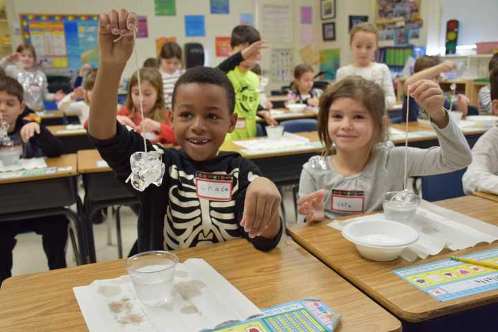 As part of the experiments, the students watched an egg get sucked into a jar, lifted ice cubes with a string, played with tornado tubes and made a cloud in the classroom.