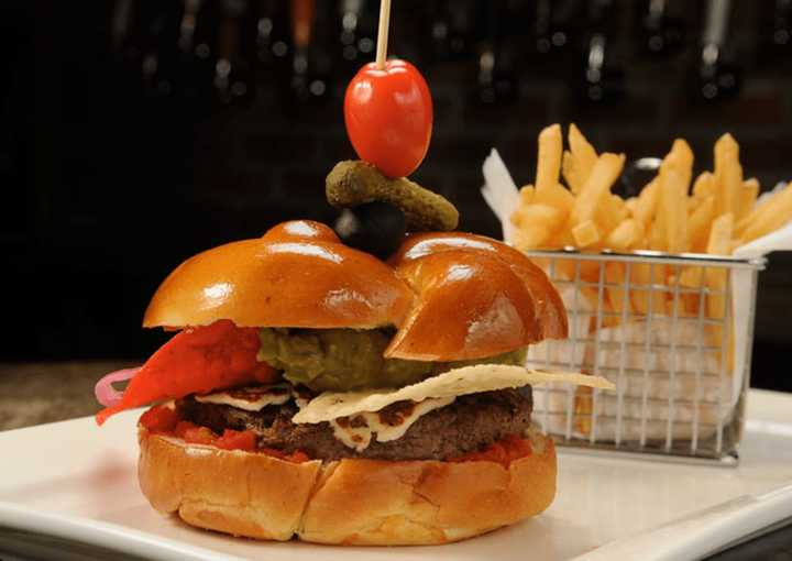 Westchester Burger Company spears all its burgers with a garnish of pickled cucumber, olive, and cherry tomato garnish.