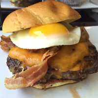 <p>The Hangover Burger at WBC is topped with a fried egg, bacon, and Monterey Jack cheese.</p>