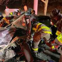 <p>Firefighters working to save the driver.</p>