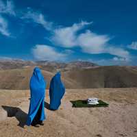 <p>The blue of the sky intensifies the blue of the burkas worn by these women in Afghanistan, one of whom is in labor.</p>