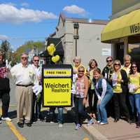 <p>On Arbor Day, Weichert Realtors hand out trees to passersby to create a greener town.</p>