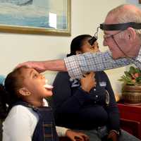 <p>Dr. Lee Eisenberg sees patients during one of his overseas trips. </p>