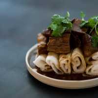 <p>House-milled steamed rice noodle rolls topped with saucy braised beef brisket.</p>