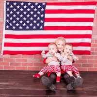 <p>Twins Joe and Jack LaPenta get a squeeze from one of their siblings at the family home in Blauvelt.</p>