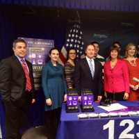 <p>Lisa Wexler, center in red, with a host of Acorda winners.</p>