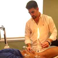 <p>Glen Rock acupuncturist Peter DeCicco performs heated cupping on a patient.</p>