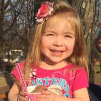 <p>Ava Sclafane enjoying her chocolate ice cream in The Erika and David Boyd Sculpture Garden, Leonia.</p>