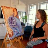 <p>Artist Nancy Parker focuses on one of her pieces at Bell-ans.</p>