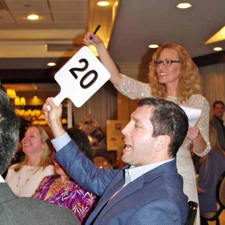 A guest places a bid during AFEE&#x27;s 20th annual Auction and Dinner.