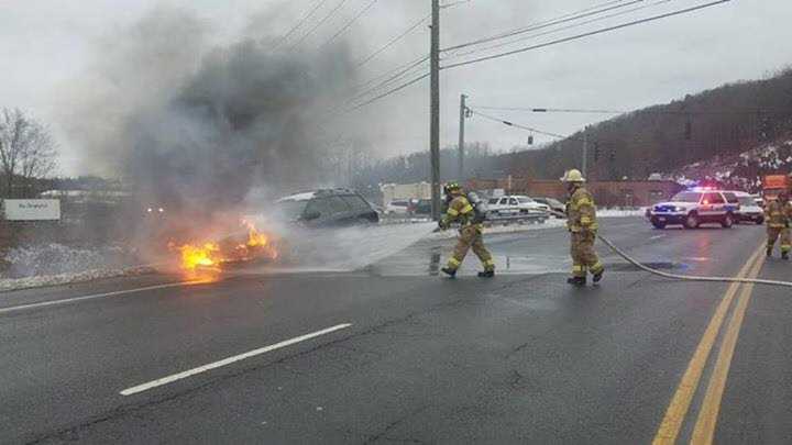 A car is shown engulfed Tuesday morning in Brookfield.