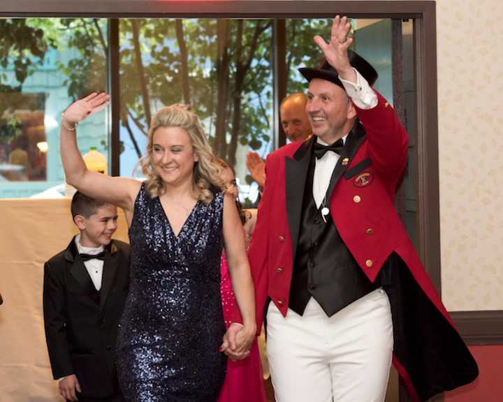 Jason Julian, the Barnum Festival Ringmaster, waves to the crowd along with his wife, Tammy.