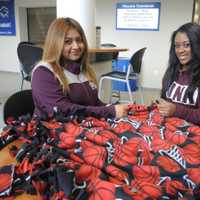 <p>Berkeley College students Eneyda de Dios of Paterson and Zoe Patterson of Elmwood Park work on blankets for Project Linus.</p>