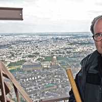 <p>American composer Joseph Bertolozzi stands atop the Eiffel Tower where he created.musical works just released as a CD.</p>