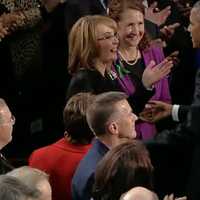 <p>Gabrielle Giffords reaches out to President Barack Obama before the State of the Union Address begins Tuesday night. Giffords, a former Congresswoman and gun violence victim, is sitting with U.S. Rep. Elizabeth Esty (D-Conn., 5th District).</p>