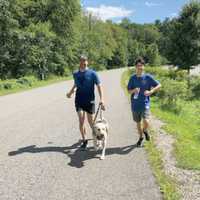 <p>Thomas Panek runs with his son and his guide dog Blaze.</p>