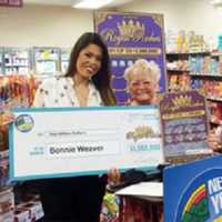 <p>Hopewell Junction resident Bonnie Weaver, right, and an unidentified woman hold a facsimile of her winnings from a $1 million &quot;Royal Riches&quot; scratch-off card.</p>