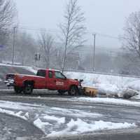 <p>A truck with a plow goes to work on the Kohl&#x27;s parking lot in Brookfield on Federal Road in Brookfield on Friday.</p>