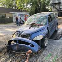 <p>The 2006 Chrysler RT Cruiser being pulled out of the living room of a home in the 1000 block of Columbia Avenue Lancaster, Pennsylvania.</p>