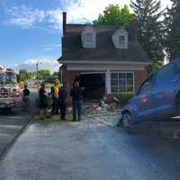 <p>The 2006 Chrysler RT Cruiser being pulled out of the living room of a home in the 1000 block of Columbia Avenue Lancaster, Pennsylvania.</p>