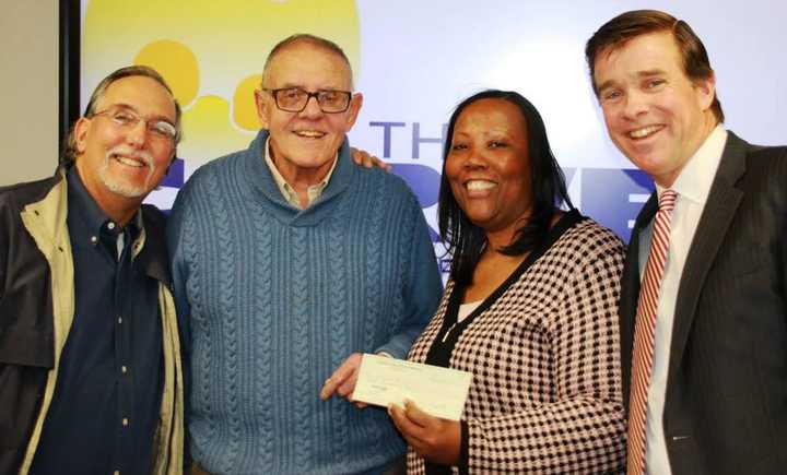 Tom Chiappetta, left, Executive Director of the Fairfield County Sports Commission donates to the Carver Center in Norwalk, with (left to right) Dick Whitcomb, Novelette Peterkin and Joe Gallagher.