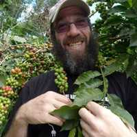 <p>Mike Love, co-owner of Coffee Lab Roasters in Tarrytown, communes with the source of the coffee beans he roasts up for his green cafe.</p>