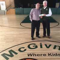 <p>Fairfield County Sports Commission Executive Director Tom Chiappetta, left, presents a check to Terry O&#x27;Connor of the McGivney Center in Bridgeport.</p>