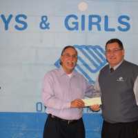 <p>Tom Chiappetta, left, Executive Director of the Fairfield County Sports Commission, presents a check to Mike Cotela of the Stamford Boys &amp; Girls Club.</p>