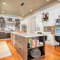 <p>The gourmet kitchen includes high-end appliances, shelves, and under-cabinet lights.</p>