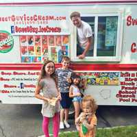 <p>John Monahan with his SweetGuy Ice Cream Truck and some very happy patrons.</p>