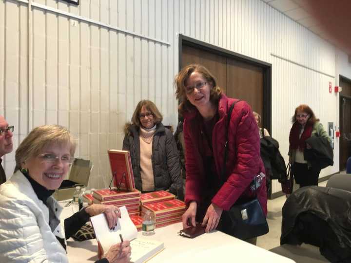 Financial writer Jane Bryant Quinn signs her new book for Yvonne Megenis of Trumbull and Judith Long of Southbury in an appearance Sunday at the Trumbull Library.