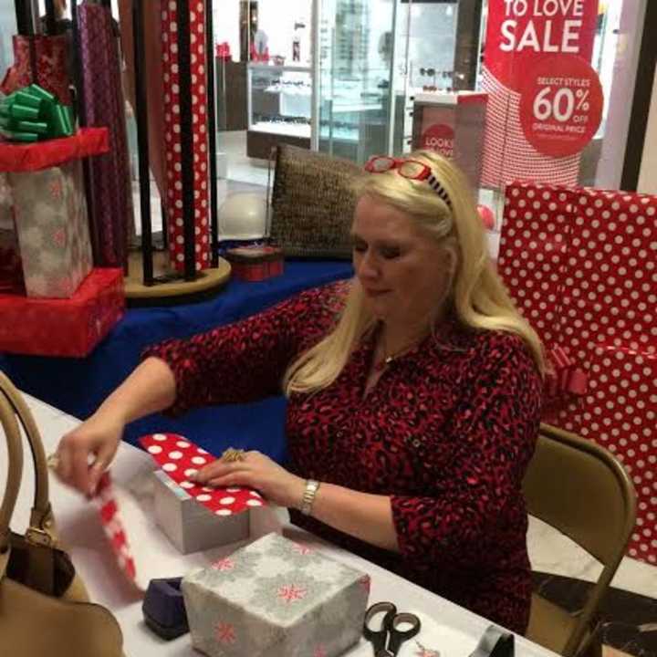 A Habitat Bergen volunteer wraps gifts at the mall. Volunteers are back to wrap Dec . 23 and Dec. 24 in Paramus and Hackensack malls.