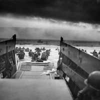 <p>Men of the 16th Infantry Regiment, U.S. 1st Infantry Division, wade ashore on Omaha Beach during the Normandy invasions on June 6, 1944.</p>