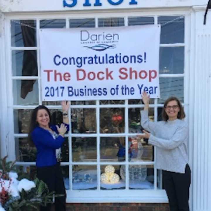 Toni Sabia, owner of The Dock Shop and Susan Cator, DCC president and executive director ,show off the banner
celebrating the awarding of “Business of the Year” to The Dock Shop for 2017.