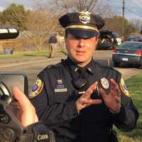 <p>Bethel Police Officer Mike Libertini answers questions Friday near the scene of an apparent attempted murder-suicide in Bethel.</p>