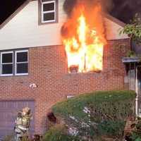 <p>Teaneck firefighters battle Van Buskirk Road blaze before dawn Tuesday.</p>