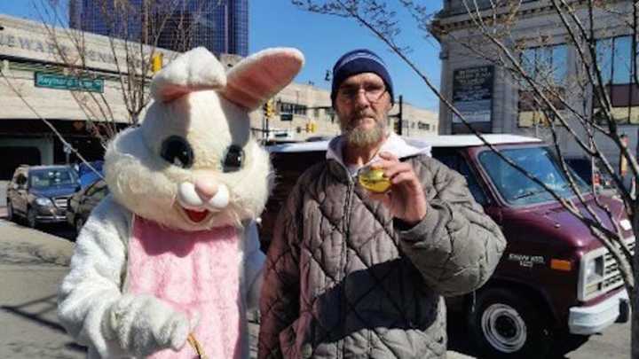 Phil Stafford with the Easter Bunny during N.J. Food &amp; Clothing Rescue&#x27;s outreach event in Newark.