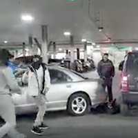 <p>Motorist stands over flattened driver as onlookers rush in at the Garden State Plaza in Paramus.</p>