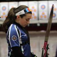 <p>Emilie Simoni prepares to shoot her bow.</p>