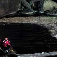 <p>City firefighters head toward the man at the base of the Great Falls in Paterson.</p>