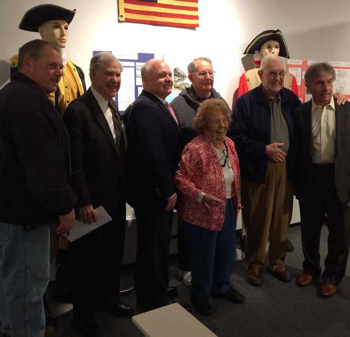 Guest curator of the Haverstraw exhibit, Corrine McGeorge, is shown with Mayor Michael Kohut, retired Judge Alfred J. Weiner, Howard Phillips, Wiliam Kohut, Joseph P. Gordon, and Isidro Cancel.