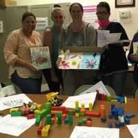 <p>Participants practice “dramatic play” at a professional development training provided by Child Care Resources of Rockland, Inc.</p>