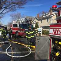 <p>Firefighters spread hose at the scene at 318 Pine Creek Ave. in Fairfield on Thursday morning.</p>