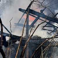 <p>The fire on the hill overlooking Greenwood Lake in West Milford destroyed one home, damaged two others and sent two firefighters to the hospital.</p>