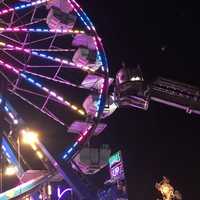 <p>Stratford firefighters rescue two riders from the Ferris wheel after it stalled Wednesday night at the Rotary Club Carnival.</p>